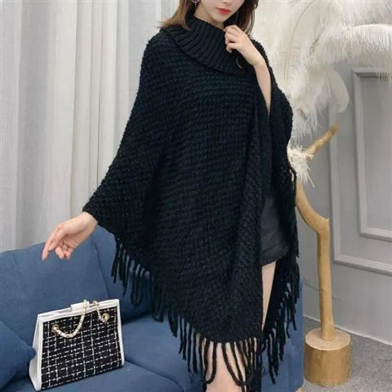 Women's triangular plush shawl cape in a cashmere blend with tassel detailing.