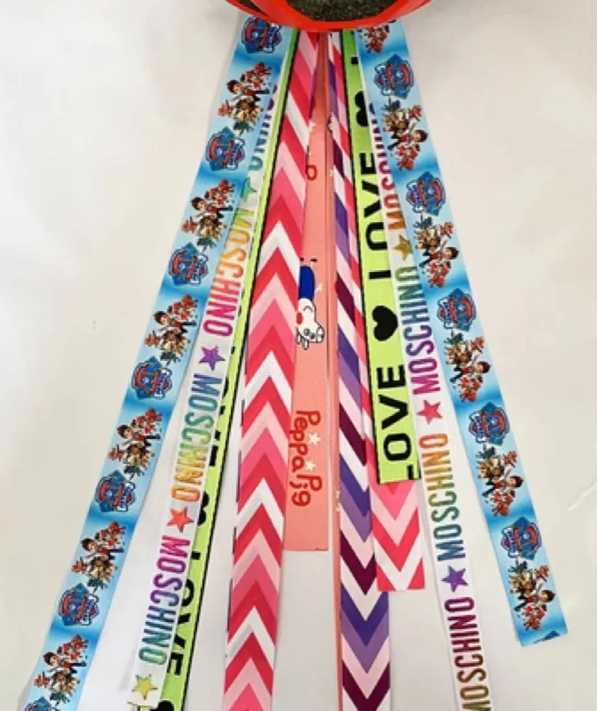 Colourful decorative ribbon streamers attached to a children safety helmet for skating or skiing