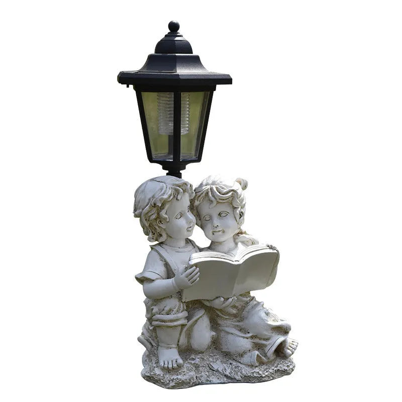 Solar hexagonal garden lamp with decorative resin figurine on plastic base for outdoor pathway lighting
