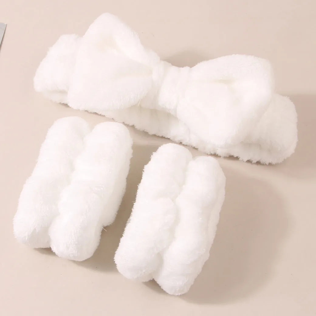 Facial brush with plastic handle and nylon bristles alongside coral fleece absorbent hair band in purple colour
