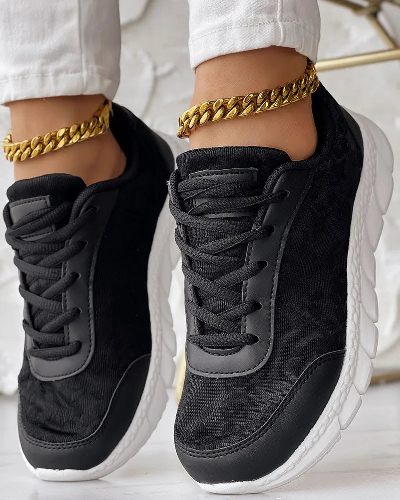 Women's white canvas casual running shoes with flat heel and round toe on a plain background.