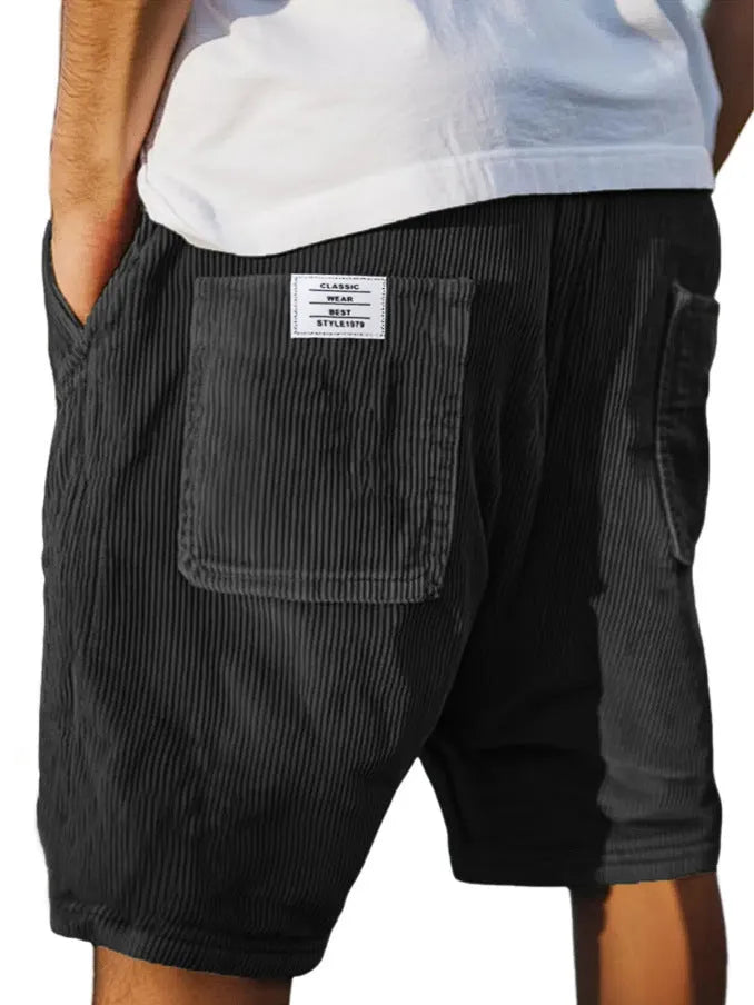 Men's grey corduroy shorts with multiple pockets and straight-leg cut on a neutral background.