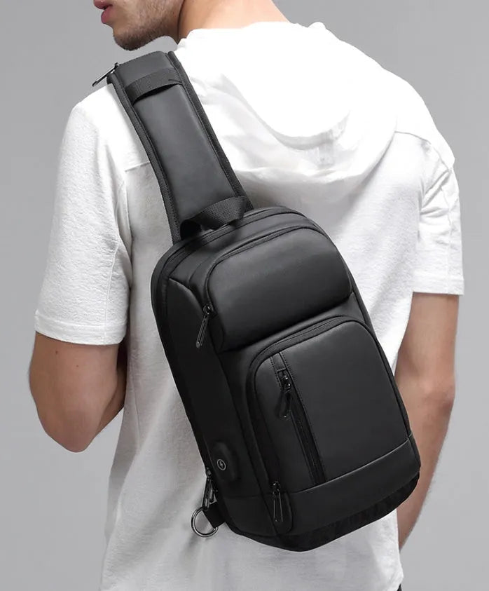 Black PVC medium shoulder bag with multiple internal compartments and adjustable strap