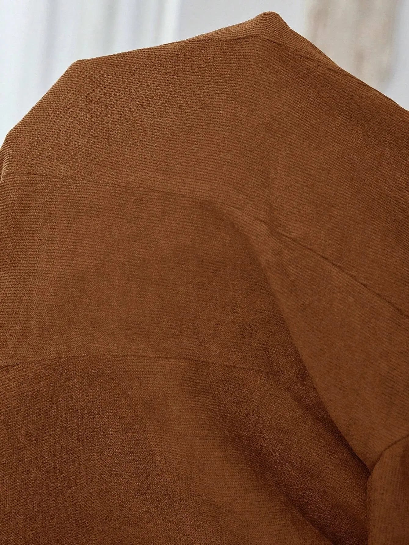 Brown men's casual suit coat with notch lapels, long sleeves, and a single-breasted button fastening.