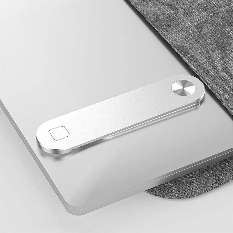 Black magnetic laptop phone holder with foldable aluminium bracket attached to a laptop screen
