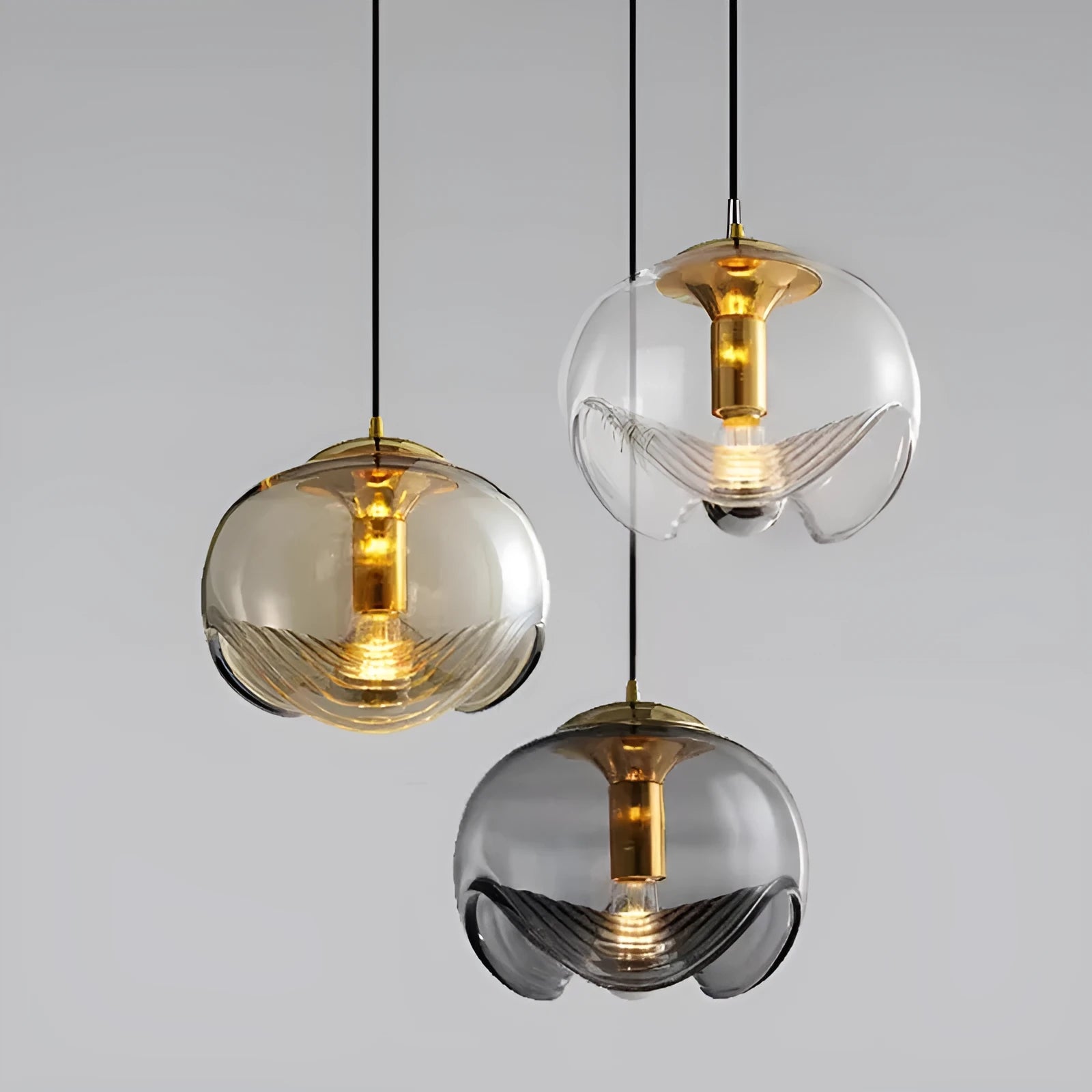 Modern minimalist glass pendant chandelier with a 25cm diameter, shown in transparent, amber, and smoky grey colour options.