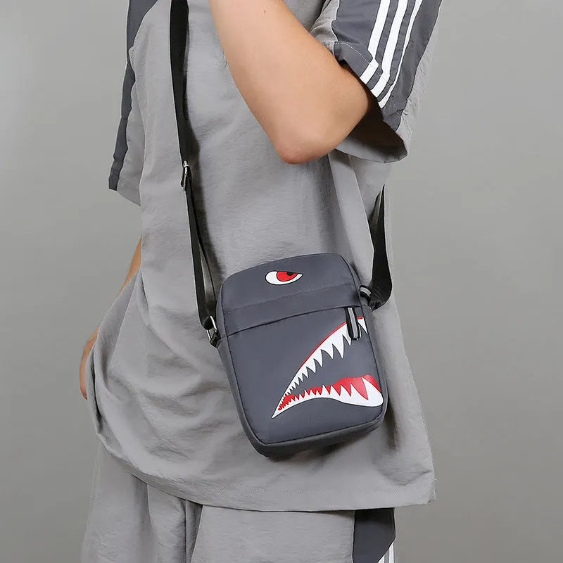 Men's small black Oxford cloth crossbody bag with animal print pattern and shoulder strap.