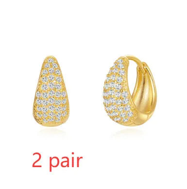 Geometric brass earclip earrings with round elements in golden and gold finishes