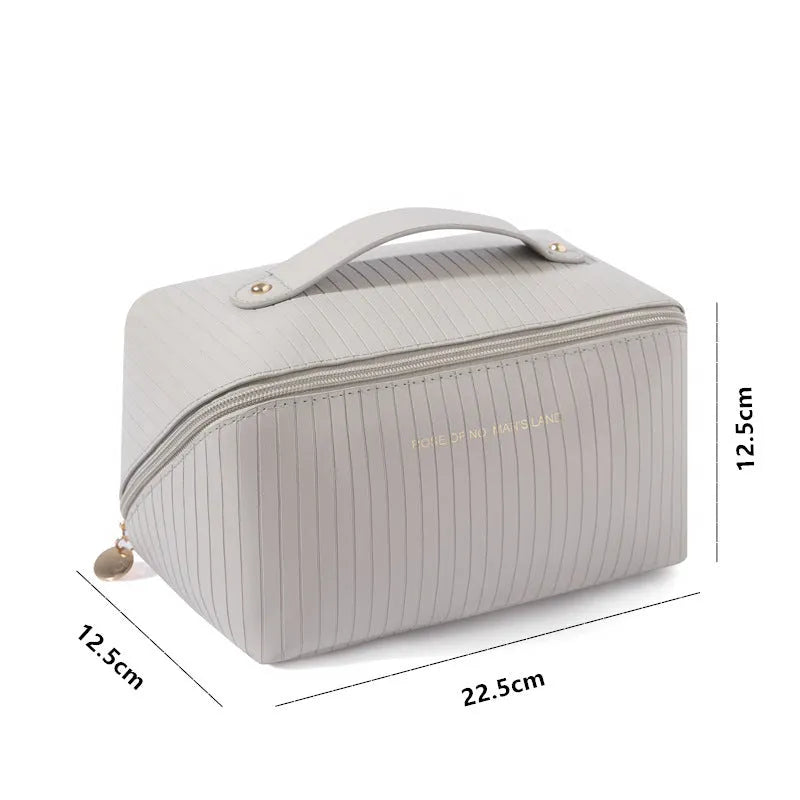 Vertical pattern pillow makeup bag in cubic design measuring 22.5cm height with travel storage capacity