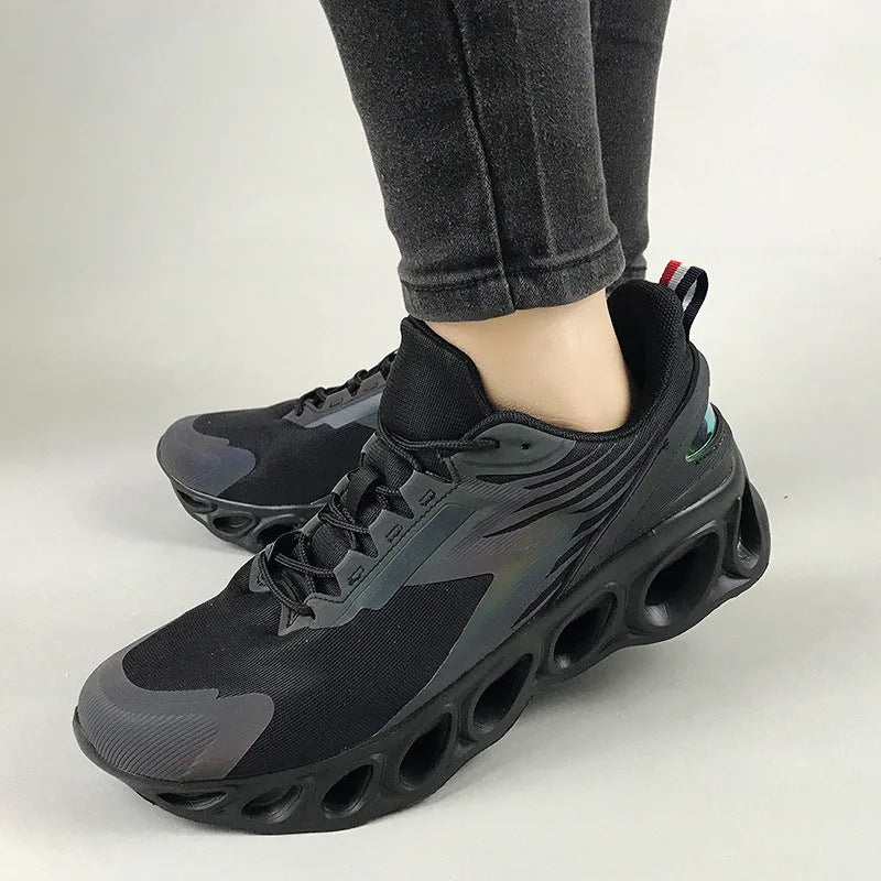 Low top casual shoes in black, white, and dark blue with mesh upper and lace-up front.