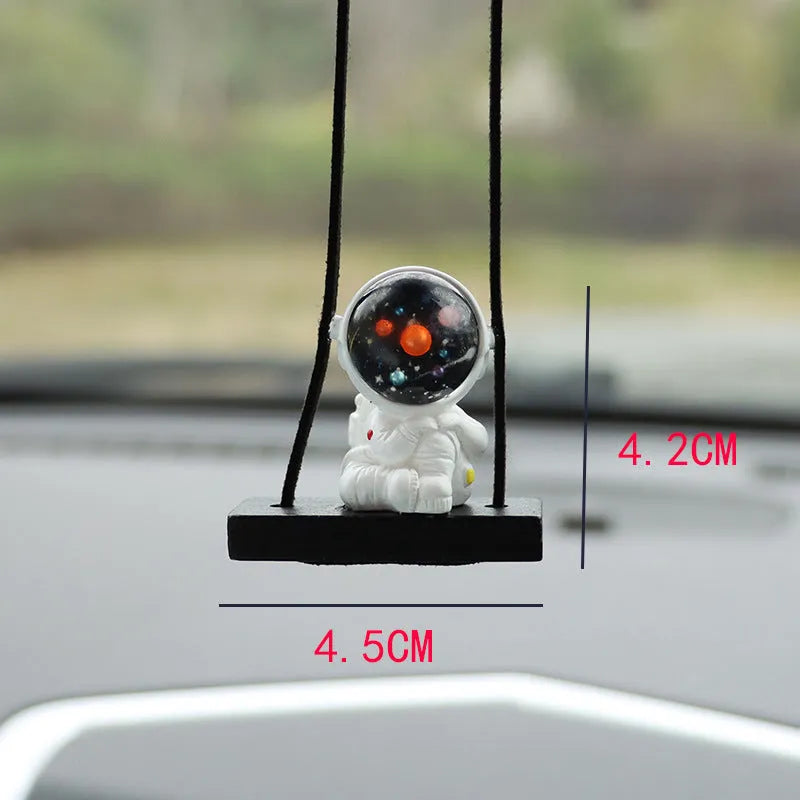 Resin astronaut car pendant in one of five cartoon colour designs