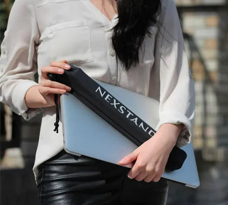 Black reinforced nylon portable folding laptop stand with 35.4cm width, shown in folded position.