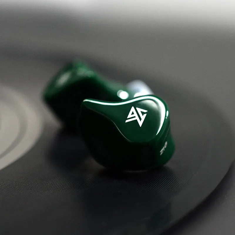Black and Green Z1 true wireless Bluetooth in-ear headphones with charging case.