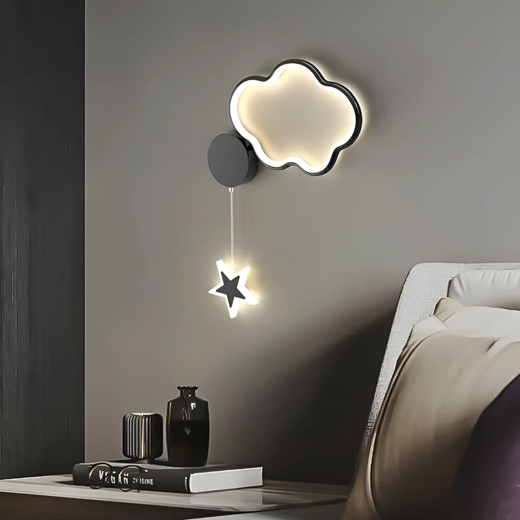 Five-pointed star shaped bedside wall lamp with cloud motif in black finish mounted beside bed