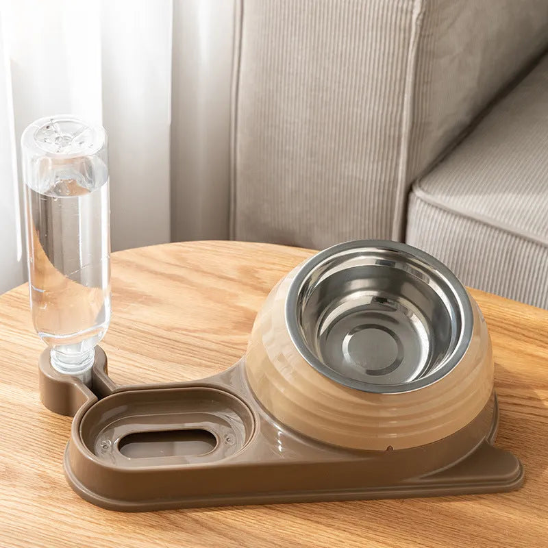 Brown elevated cat food bowl with attached water bottle dispenser on a floor.