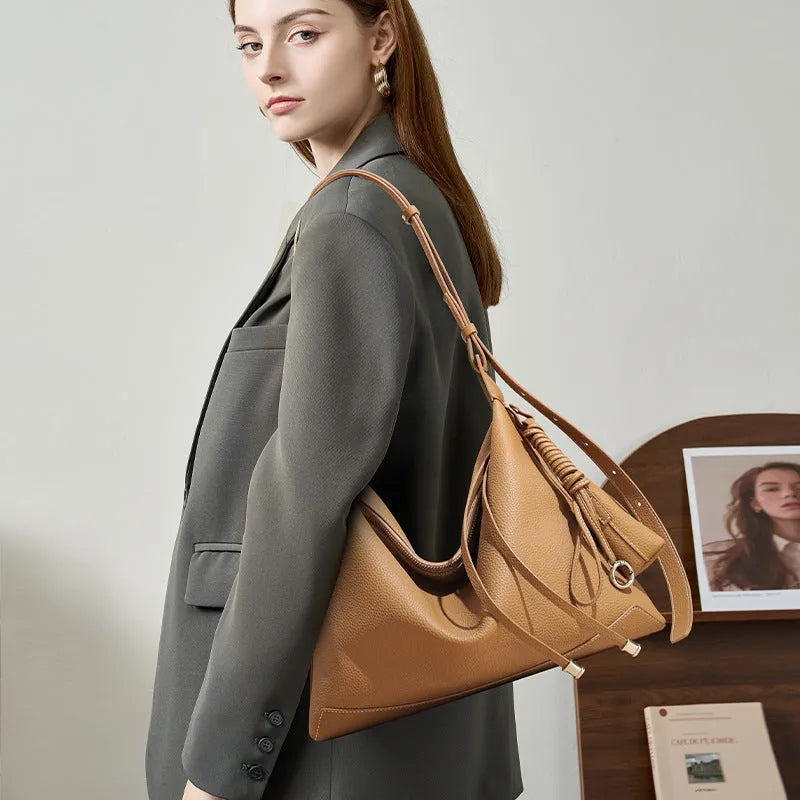 Full-grain leather women's crossbody bag in biscuit with spliced design and zip closure