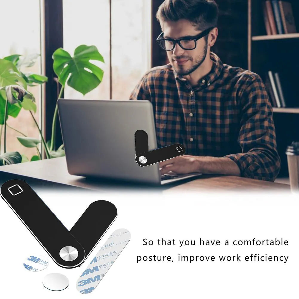 Black magnetic laptop phone holder with foldable aluminium bracket attached to a laptop screen