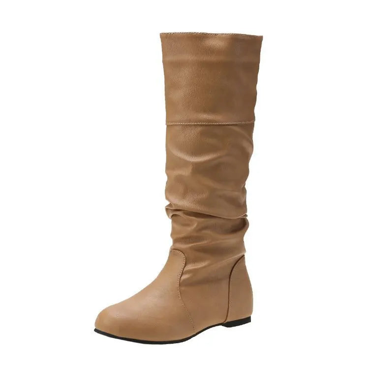 Women's flat ankle boots in black with a round toe and slip-on design on a rubber sole.