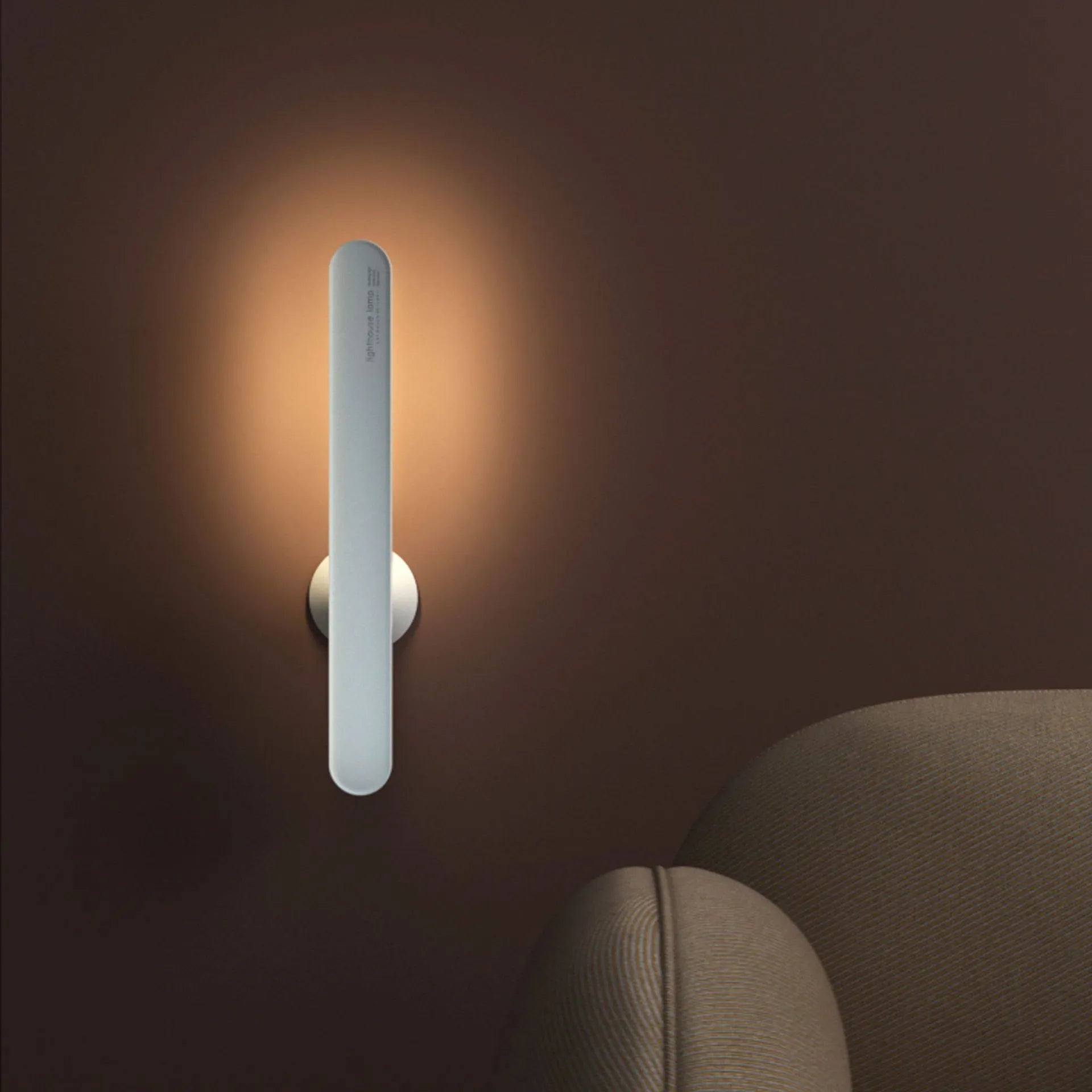 White geometric table lamp with touch switch and USB cable on a wooden desk.