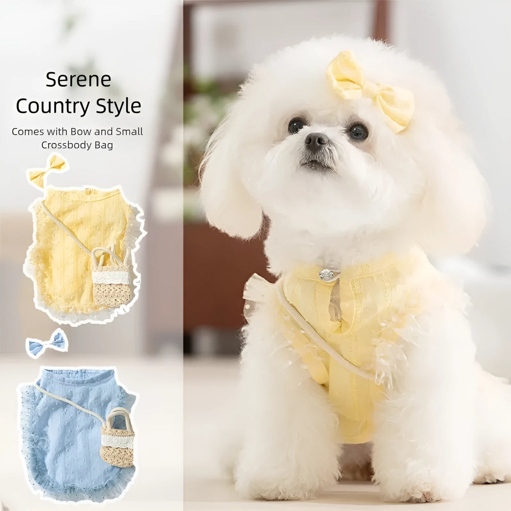 Small dog wearing quiet country shoulder bag carrier in blue, with bow and crossbody bag