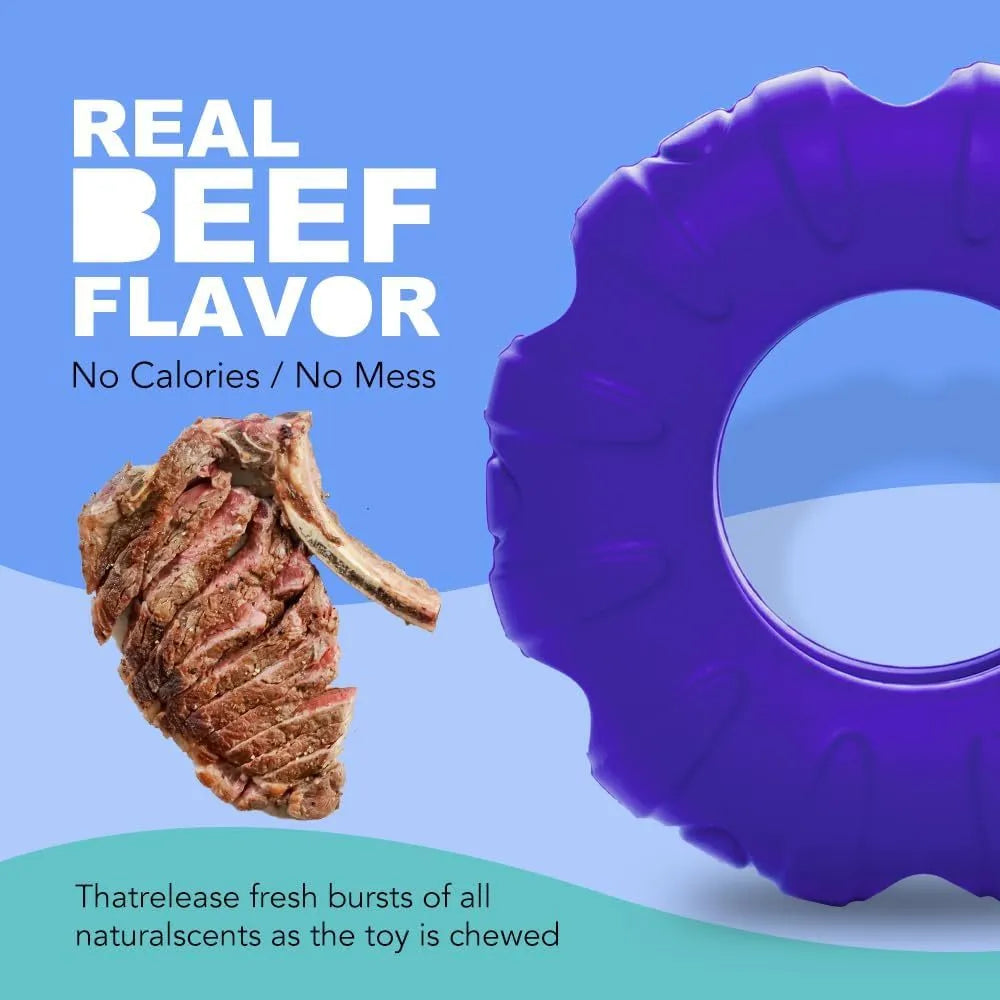 Blue rubber tire-shaped dog chew toy with oval openings for treat dispensing on a white background.