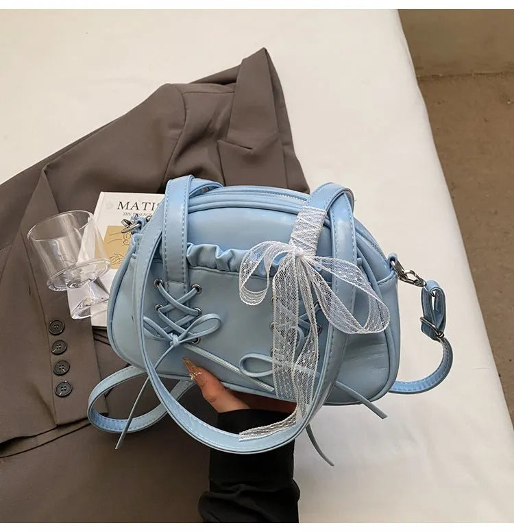 Women's casual bandage bow handbag in PU with shoulder strap and sewing thread detailing.