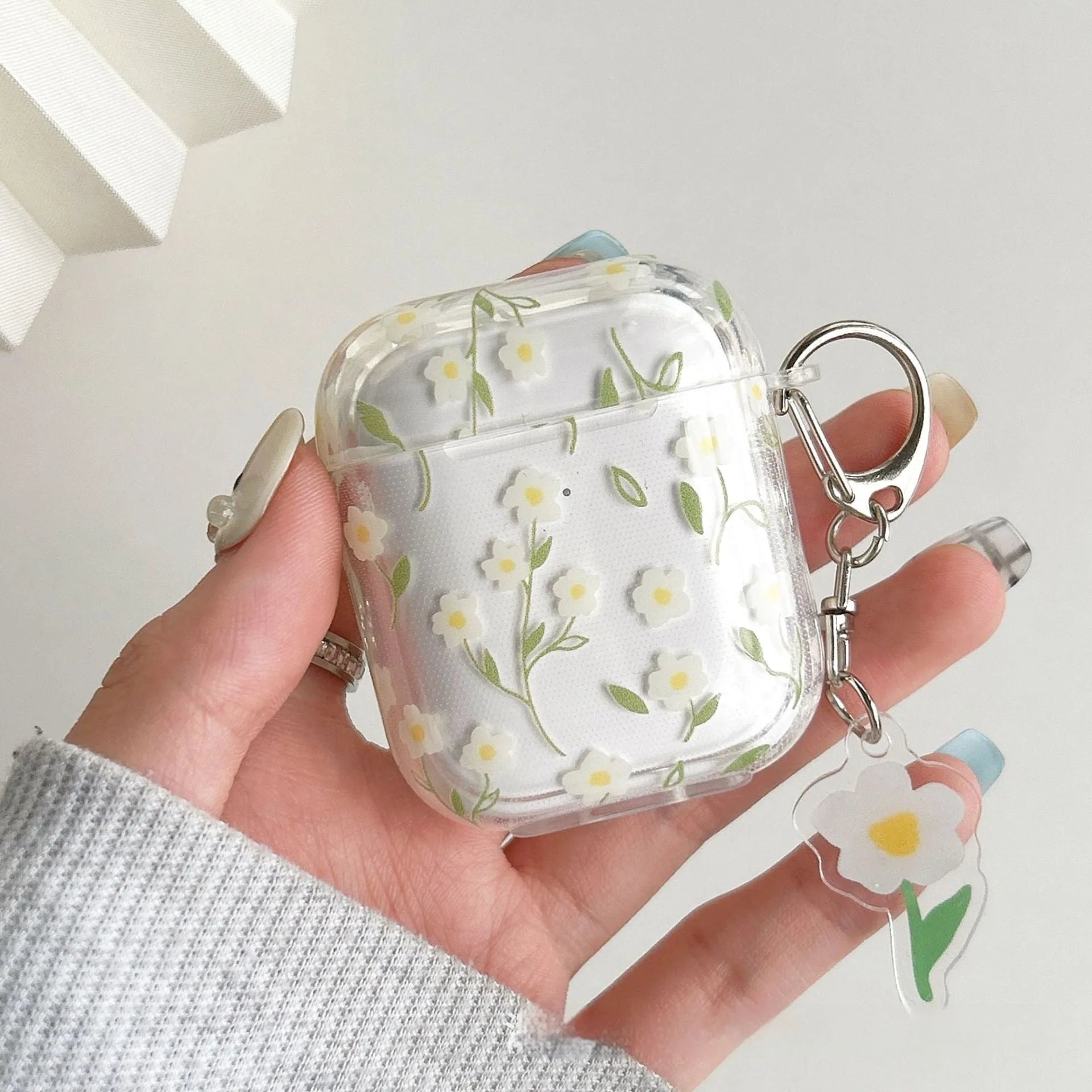 Clear TPU protective case with white floral pattern for Apple AirPods charging case
