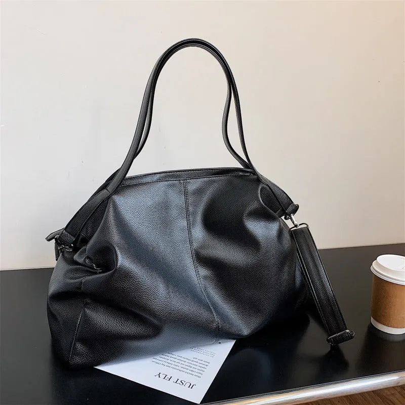 Large soft black PU messenger tote bag with car suture detailing and a long shoulder strap