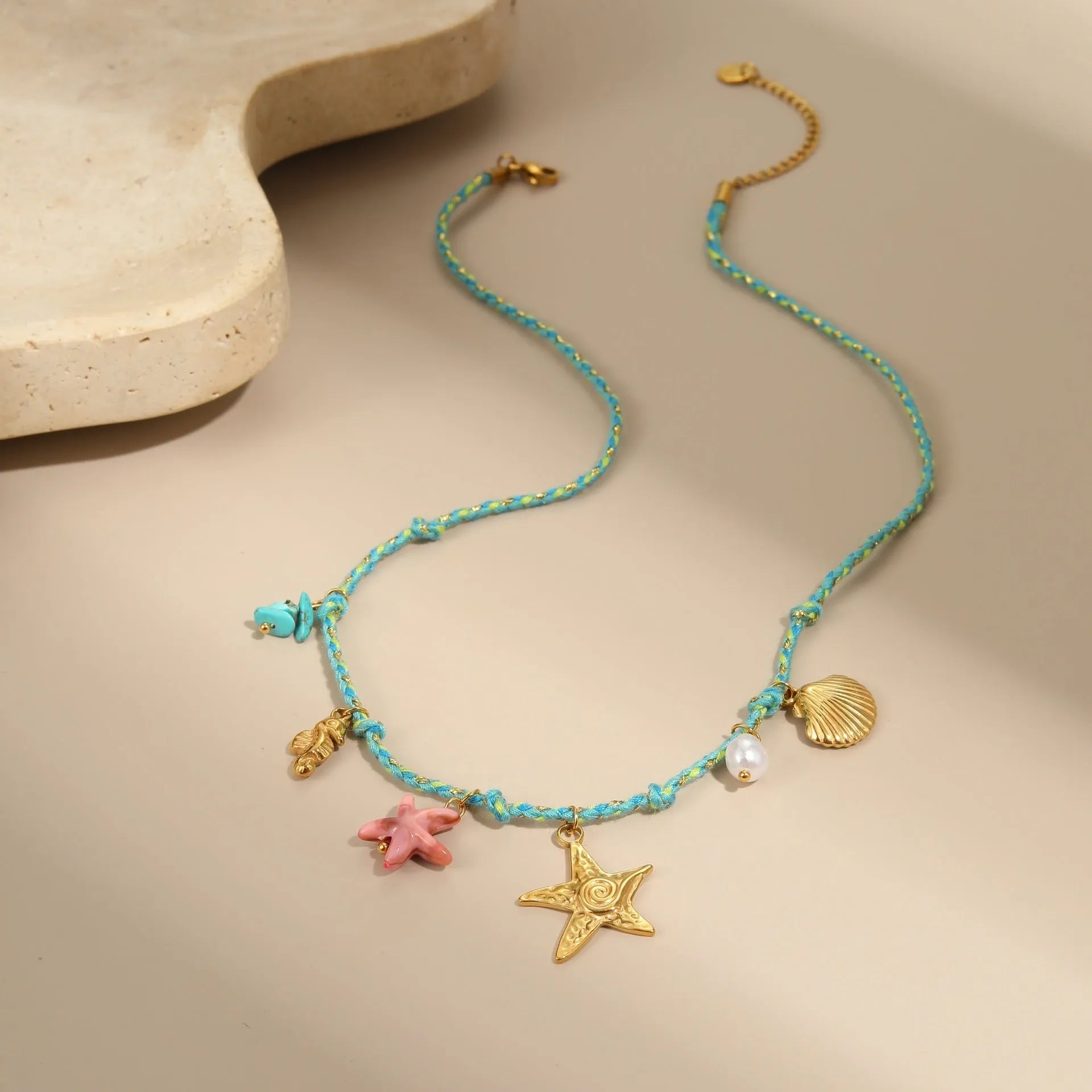 Handmade braided rope titanium steel necklace and bracelet set with 18K gold electroplated heart, star, and geometric pendants.