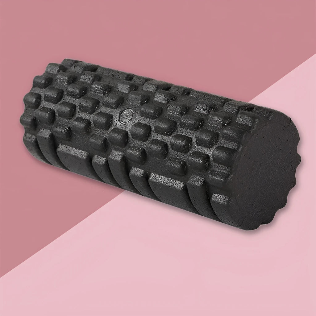 Hollow black EPP foam roller 33x14cm on flat surface for Pilates and balance exercises