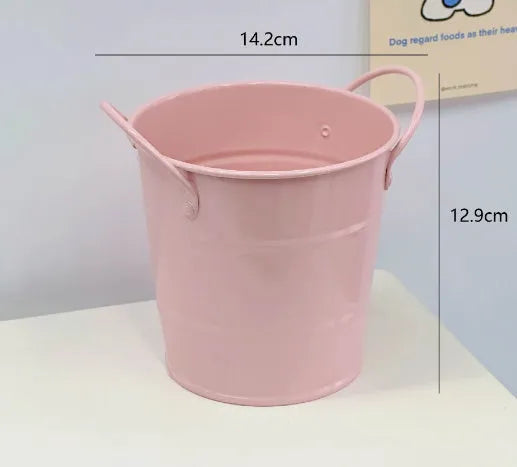 Round metal pen holder in a choice of colours including pink, green, red, white and yellow on a desk.