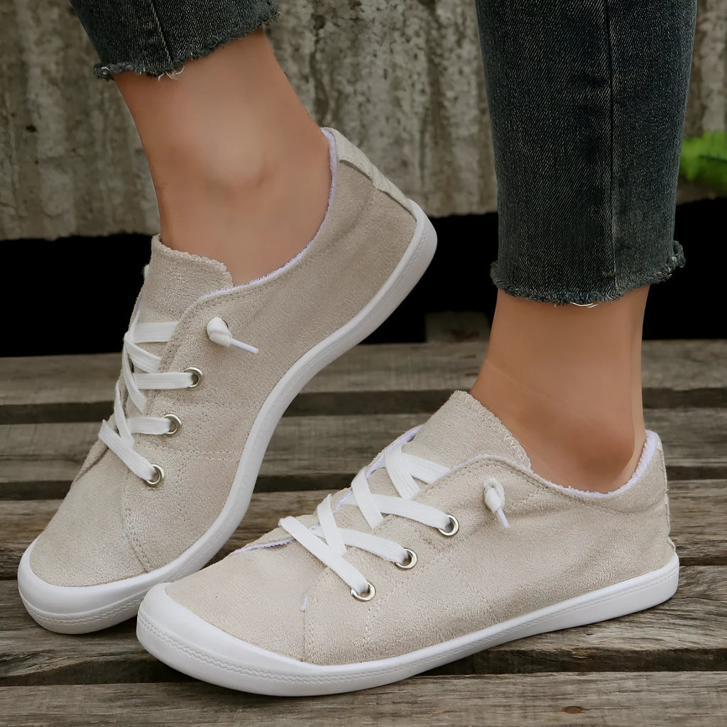 Women's creamy white low-top casual sneakers with fabric upper and rubber sole