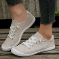 Women's creamy white low-top casual sneakers with fabric upper and rubber sole