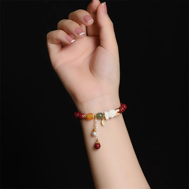 Natural cinnabar bracelet with rabbit motif in traditional Chinese design