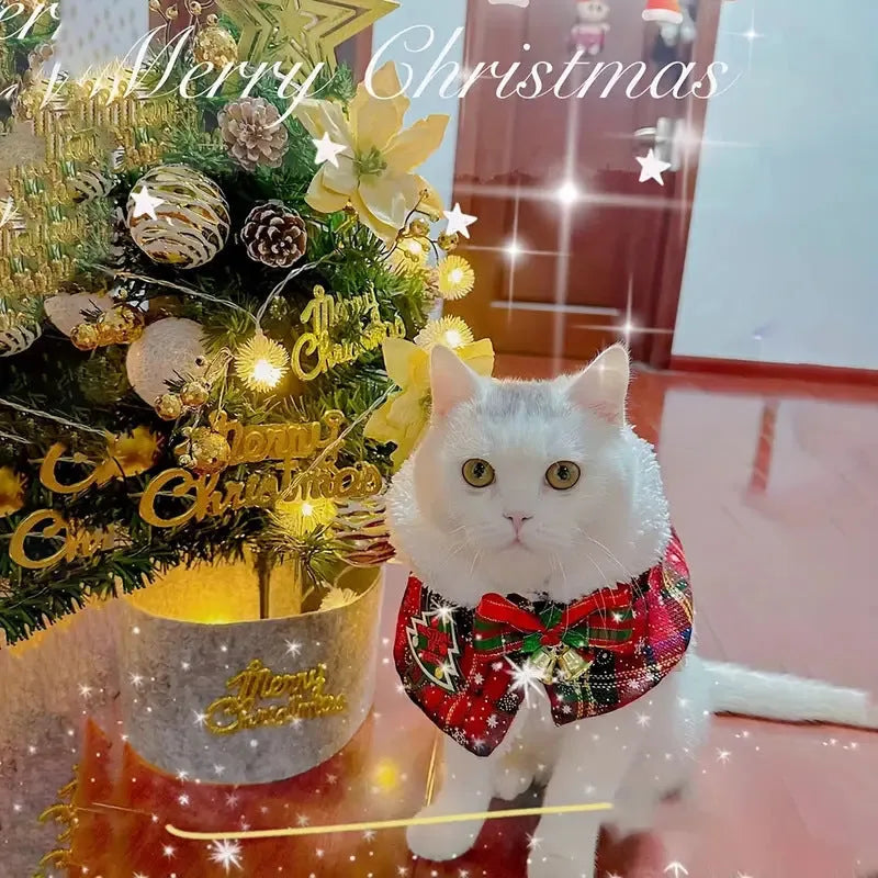 Pet wearing red Christmas cloak with bell design, draped over back with festive snowflake pattern