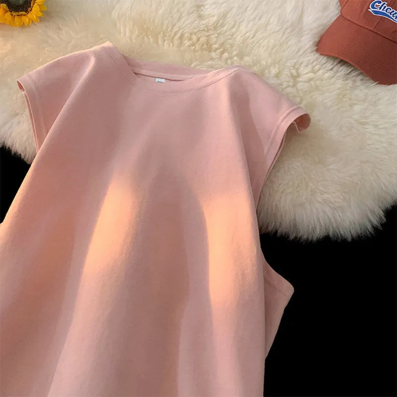 Men's loose solid colour sleeveless cotton tank top on a hanger, shown in a light apricot shade.
