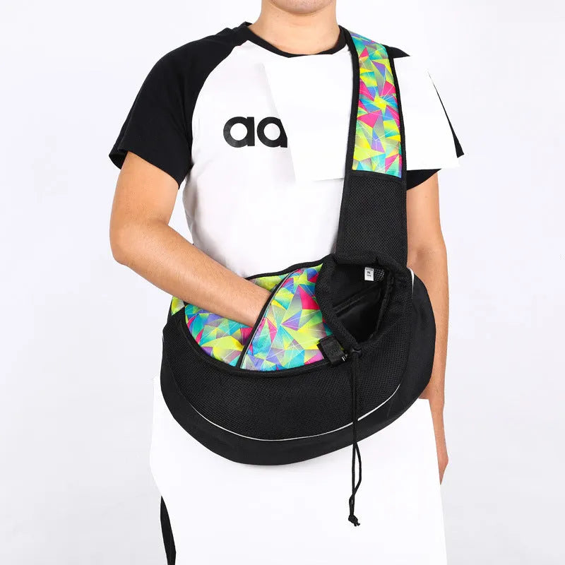 Women carrying black pet crossbody bag with small dog inside, Oxford material with drawstring closure