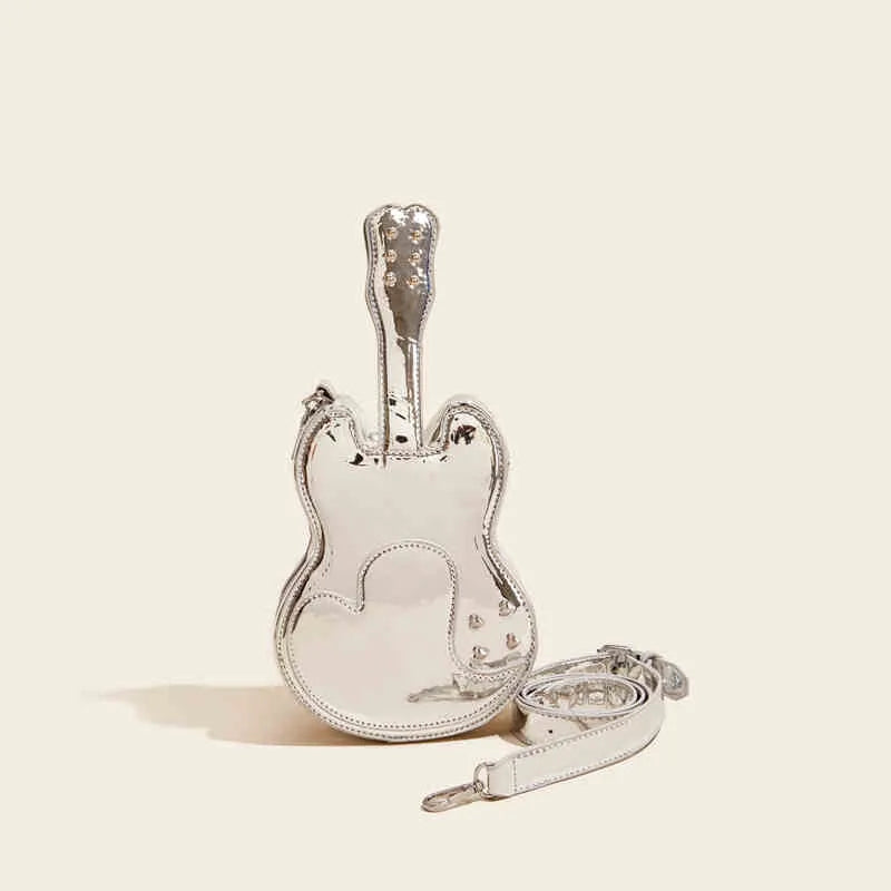 PU leather guitar-shaped crossbody bag in silver, shown with phone and wallet inside.