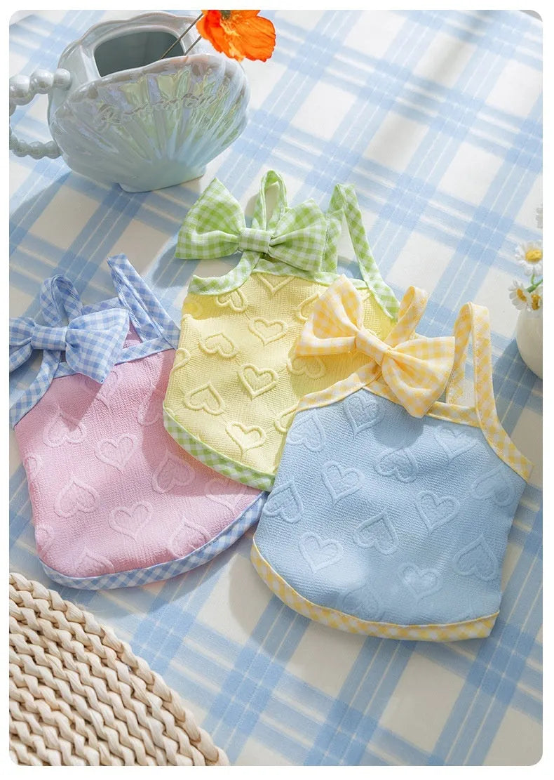Small dog wearing heart texture vest with bow suspenders in Bondi Blue colour