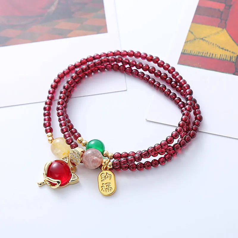 Women's adjustable garnet fox bracelet with rope closure in purplish red colour