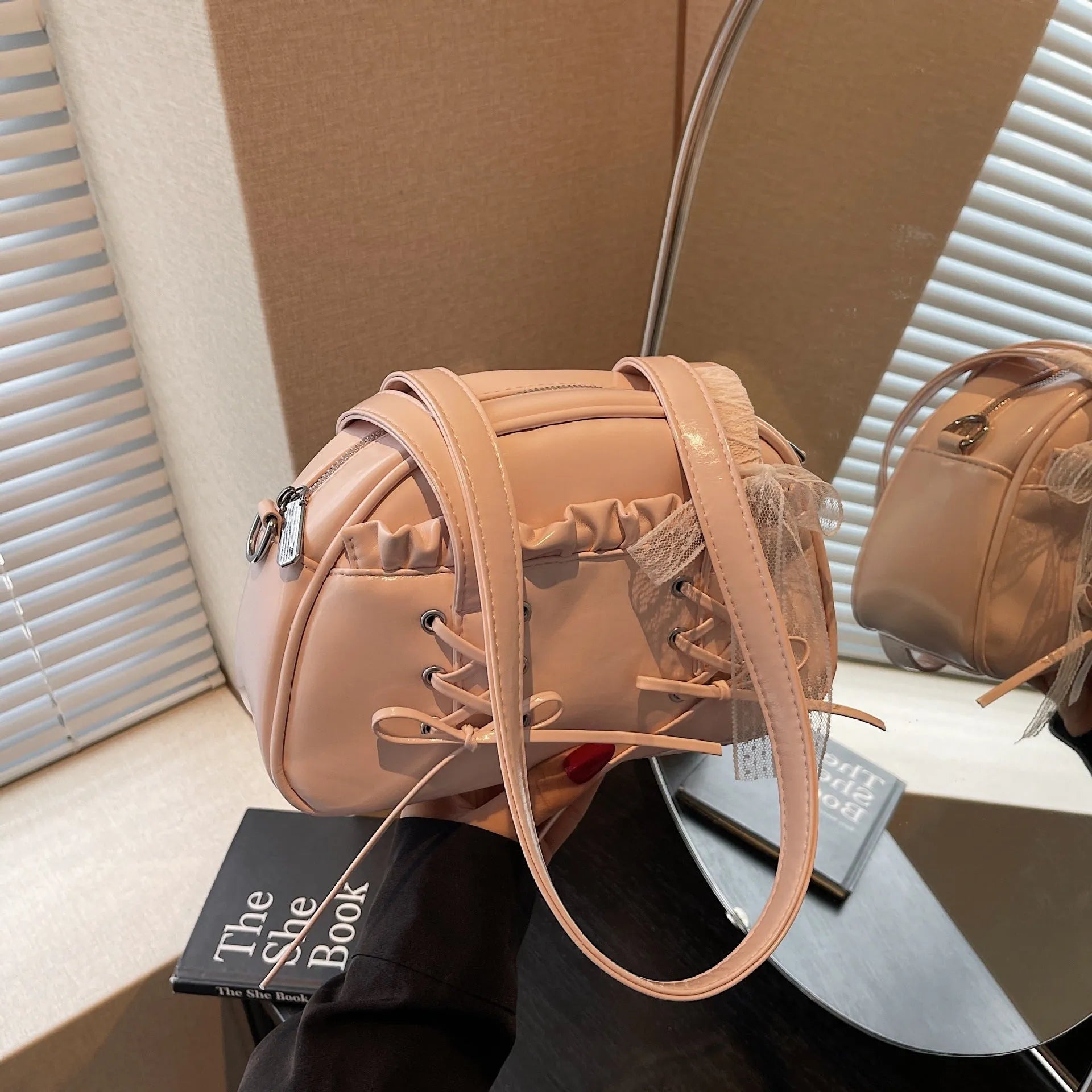 Women's casual bandage bow handbag in PU with shoulder strap and sewing thread detailing.