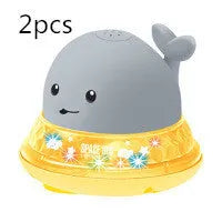 Automatic water spray whale bath toy floating in water with fountain and LED lights