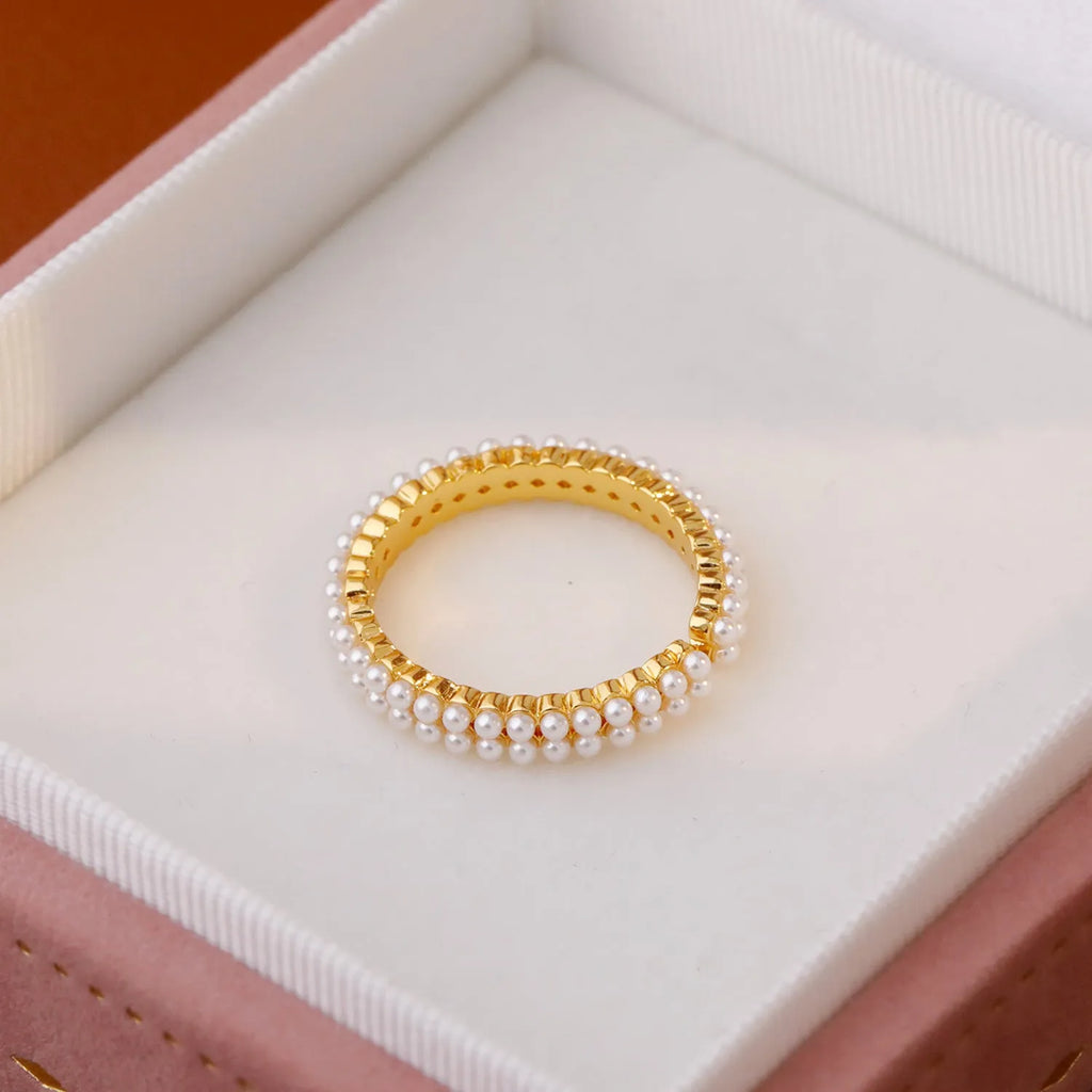 Gold geometric open mouth ring with round decorative elements on female hand