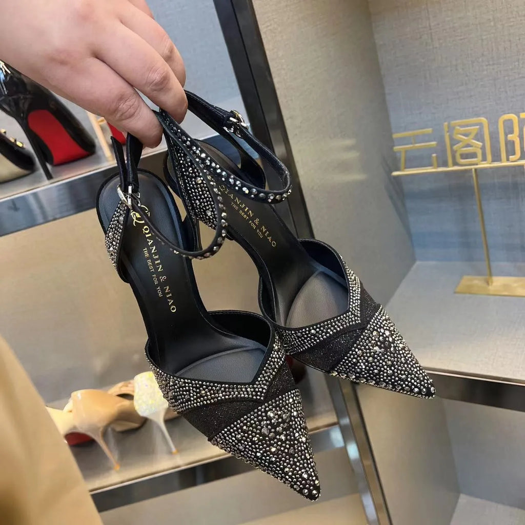 Women's black stiletto high heels with red sole and pointed toe design