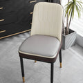 Beige leather horseshoe-shaped seat cushion with anti-slip base on a wooden chair