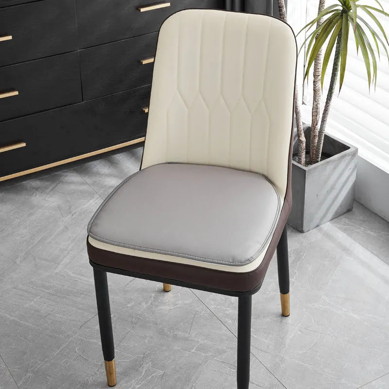 Beige leather horseshoe-shaped seat cushion with anti-slip base on a wooden chair