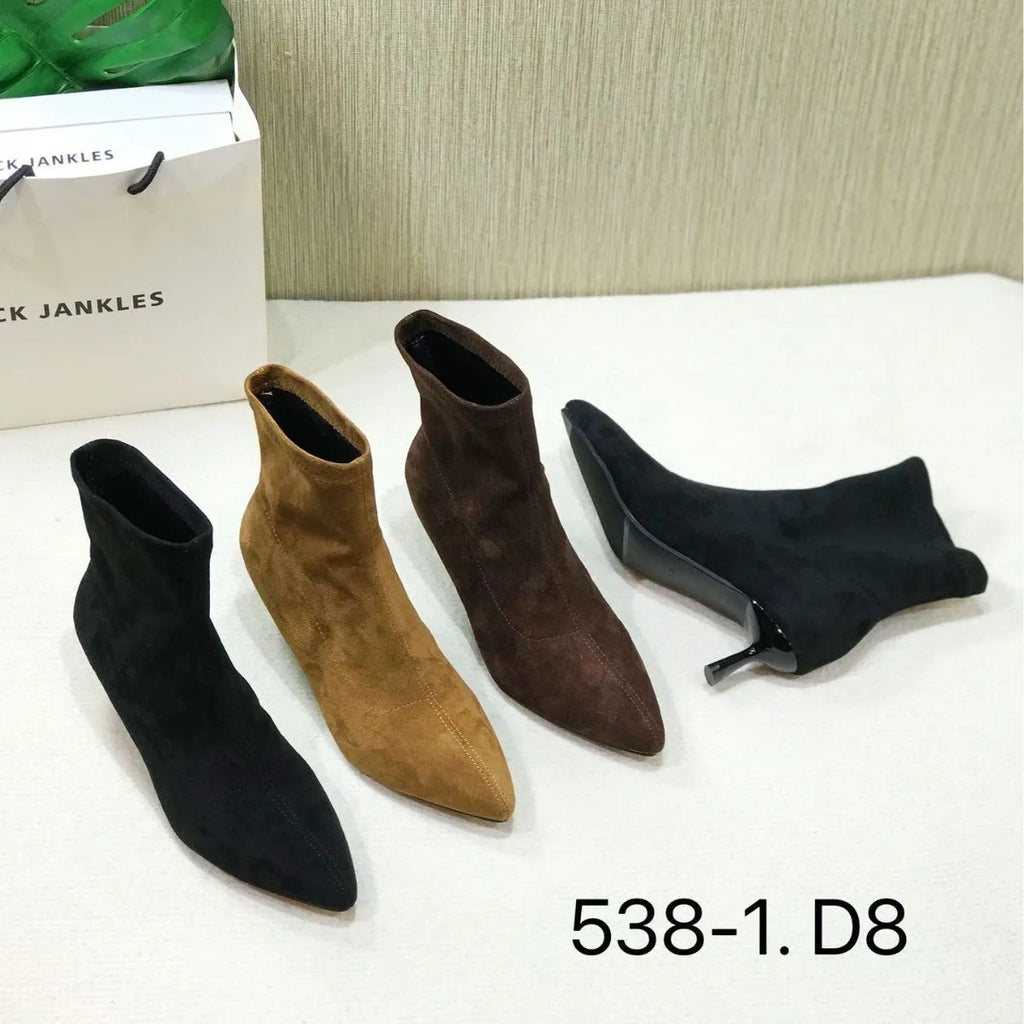 Black pointed toe women's ankle boots with a high stiletto heel on a rubber sole.