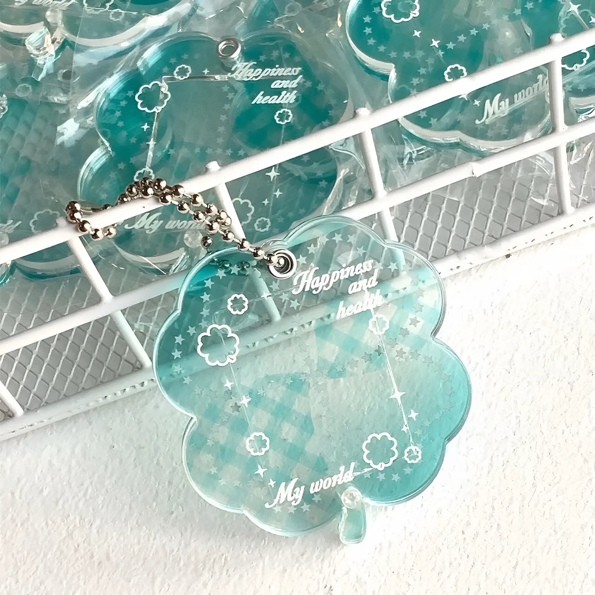 Acrylic four-leaf clover pendant keychain in blue, grass green, or mint green.