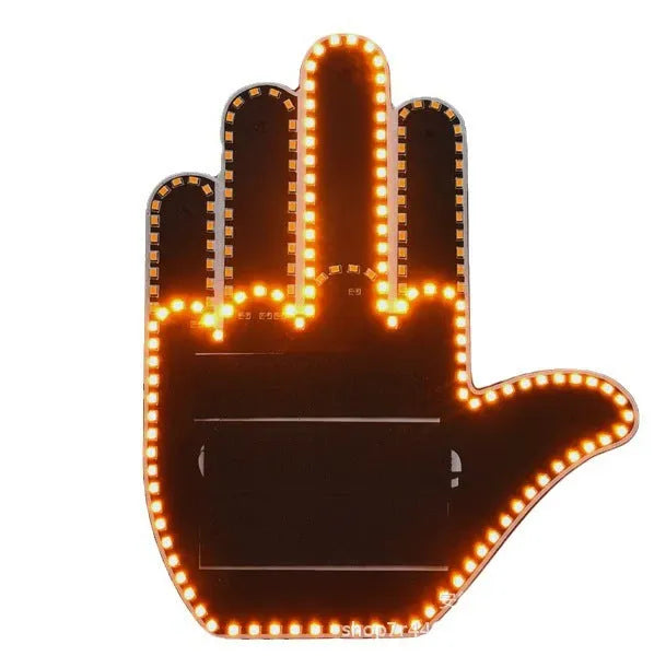 Black plastic LED gesture car light with amber LEDs showing a hand gesture, remote control, and 3M tape for mounting.