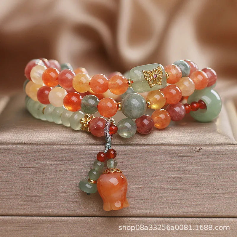Natural Jinsi Jade multi-circle bracelet with round beads and lily pendant on display